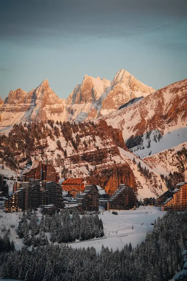 Avoriaz wood-clad ski-in ski-out residences below peaks glowing at sunset