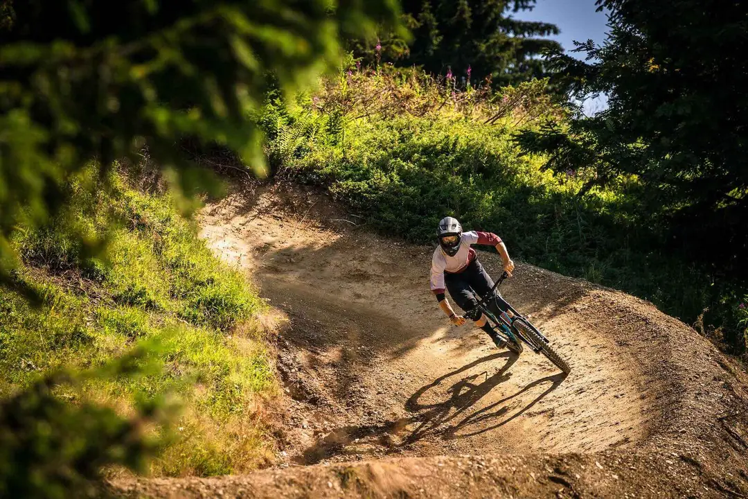 Mountain biker on a berm of the Les Gets bike park in summer, Portes du Soleil