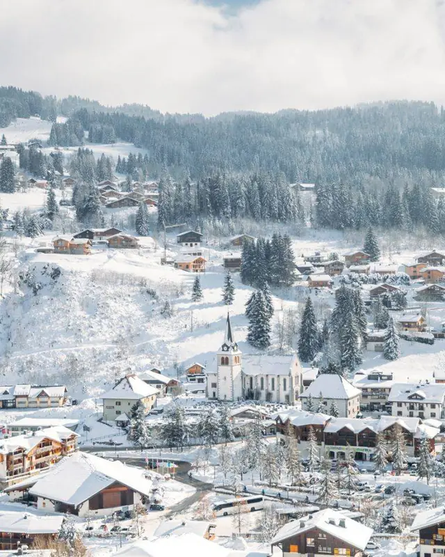 The snow-covered village and church of Les Gets in winter