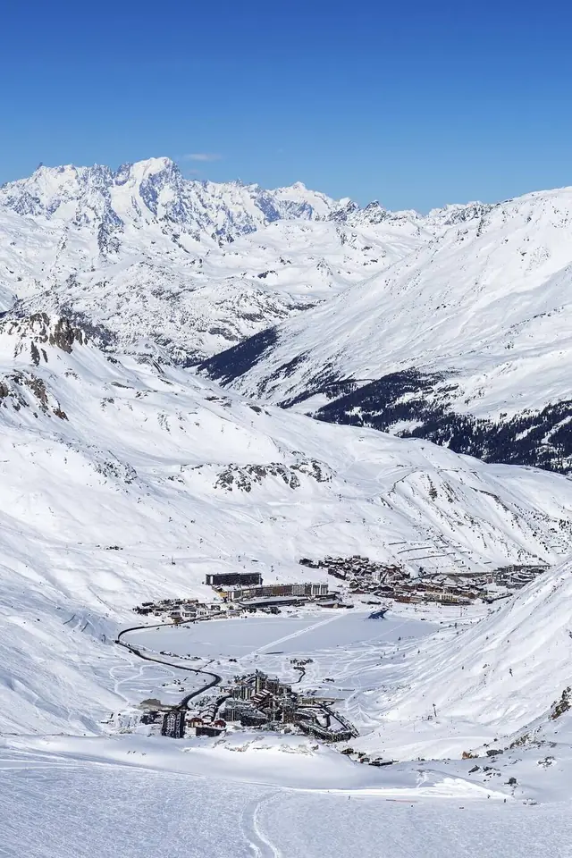 Tignes ski resort and its frozen lake seen from the slopes, Mont Blanc beyond